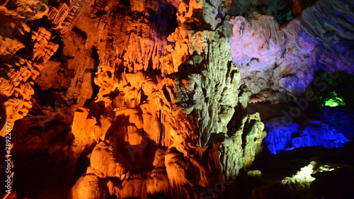 Colorized Stalactites hang from Cave Ceiling in Ha Long Bay Vietnam
