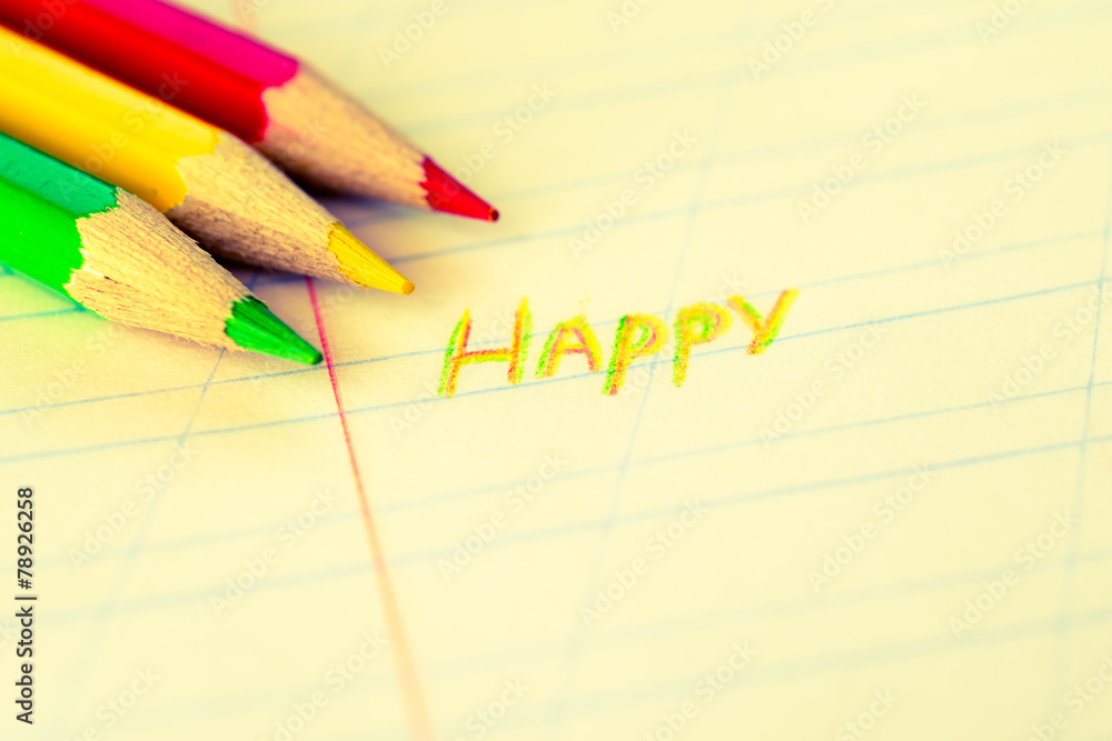 Happy sign by crayons in the notebook Happy sign by crayons in the notebook