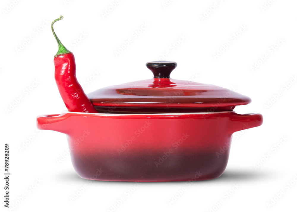 In front red chili pepper in saucepan with lid In front red chili pepper in saucepan with lid