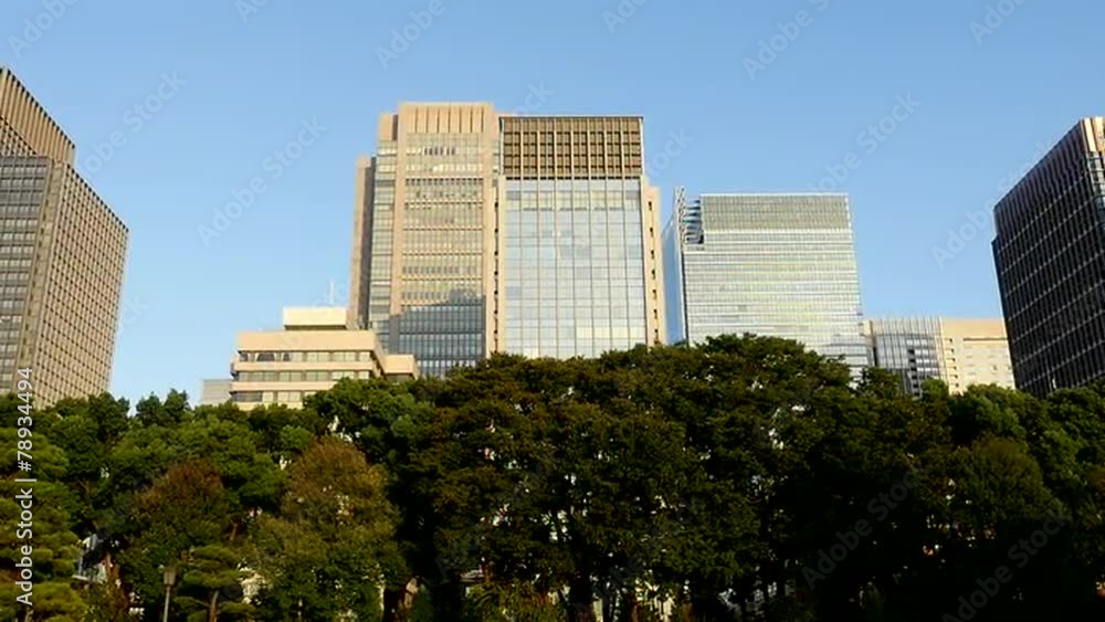 Zoom Out of Office Buildings Surrounded by Trees in Central Tokyo Japan Zoom Out of Office Buildings Surrounded by Trees in Central Tokyo Japan