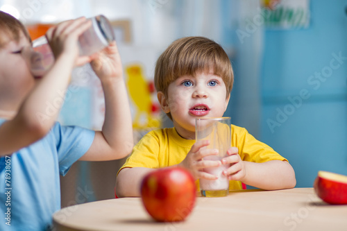 children drinking milk at home