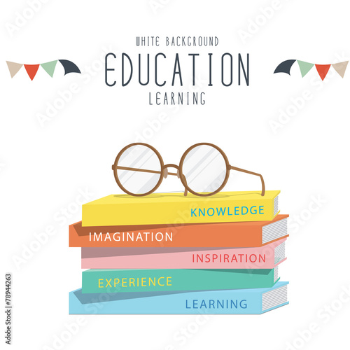 Eyeglasses on top stack books.