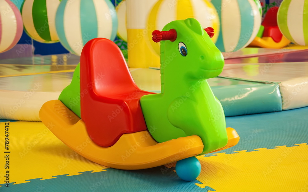 Obraz premium Bright toy rocking horse on the playground
