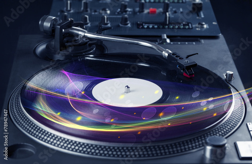 Turntable playing vinyl with glowing abstract lines