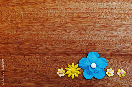 yellow and blue  paper flower on wooden background