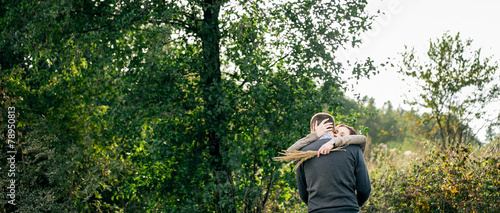Young couple hugging in a forest