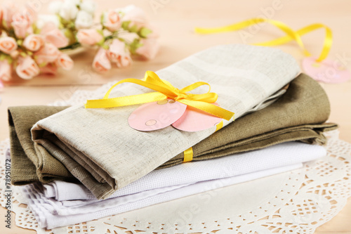 Napkins with Easter decorations  on color wooden background