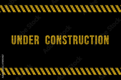 Under construction road sign in yellow on black with stripes