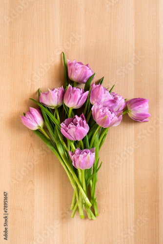 Colorful tulips on wooden background