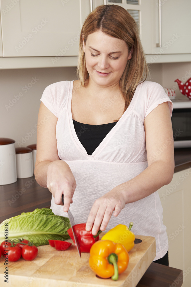 Pregnant Woman Chopping Up Fresh Vegetables