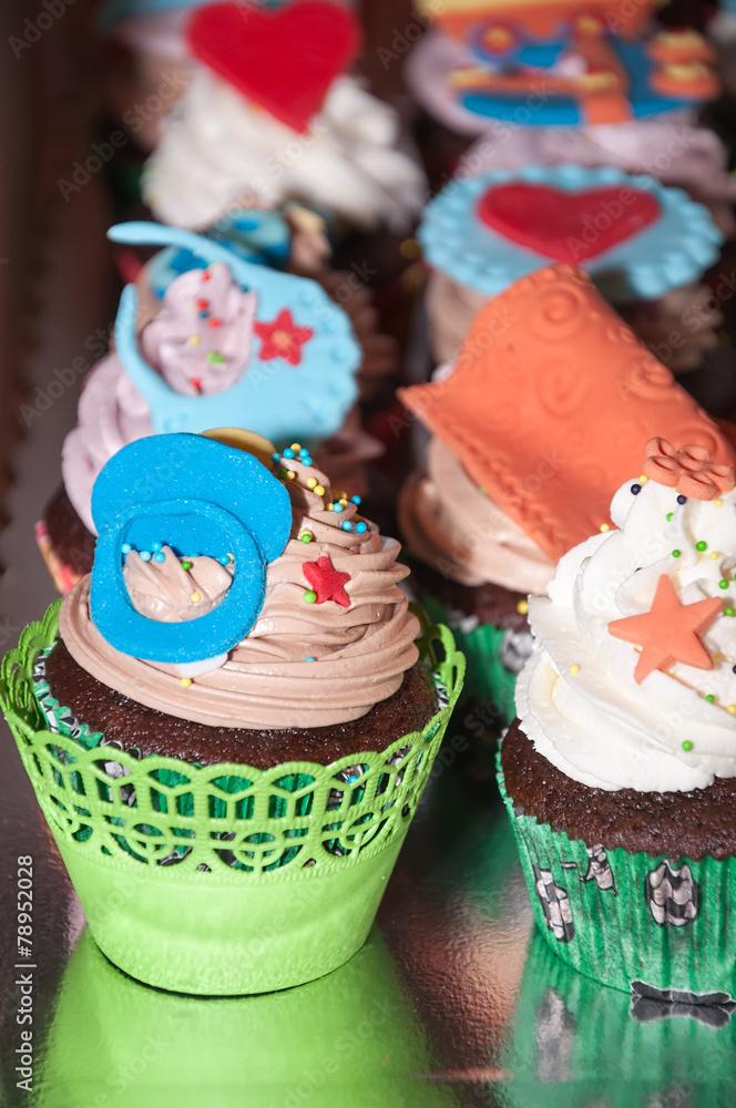 Cupcake with colorful figures made of fondant