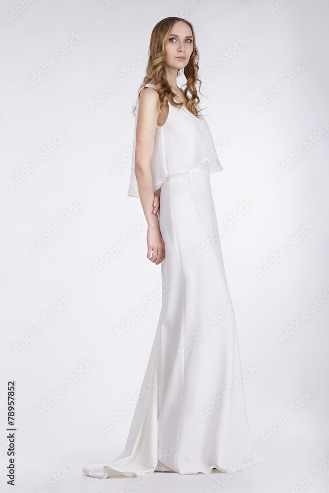 Femininity. Cute Young Woman Standing in White Dress Femininity. Cute Young Woman Standing in White Dress