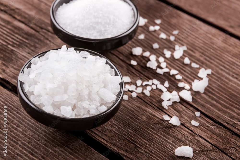 sea salt in bowl on wooden background sea salt in bowl on wooden background