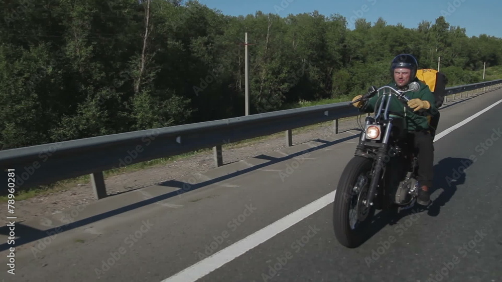 Motorcyclist posing on camera Motorcyclist posing on camera