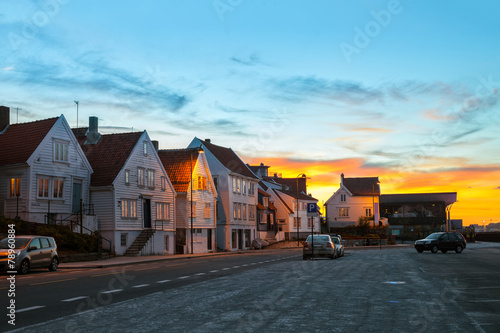 Street with white houses at sunset in Stavanger, Norway.