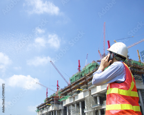 Construction worker talking on a smart phone