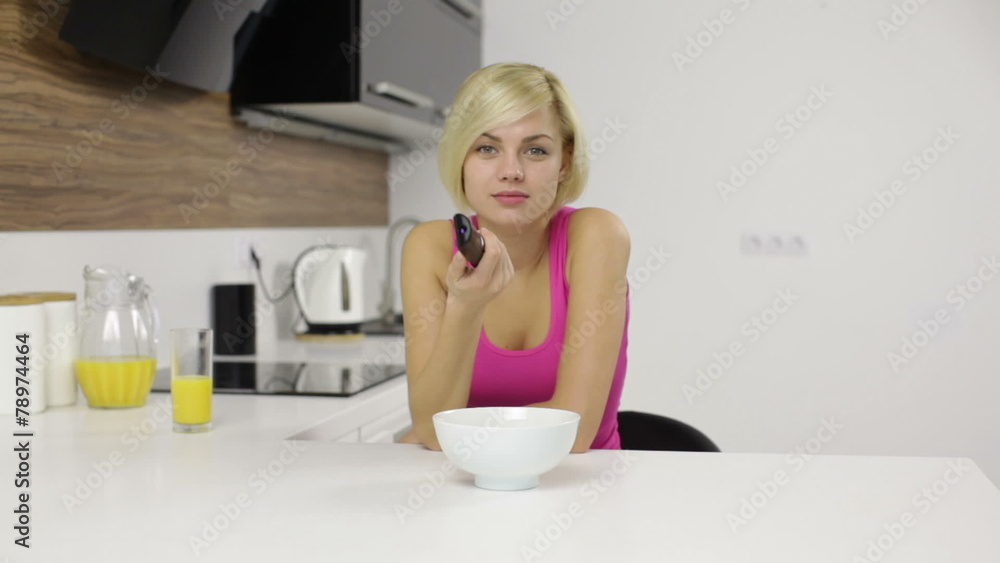 woman watching serious interesting tv hold remote control eat woman watching serious interesting tv hold remote control eat