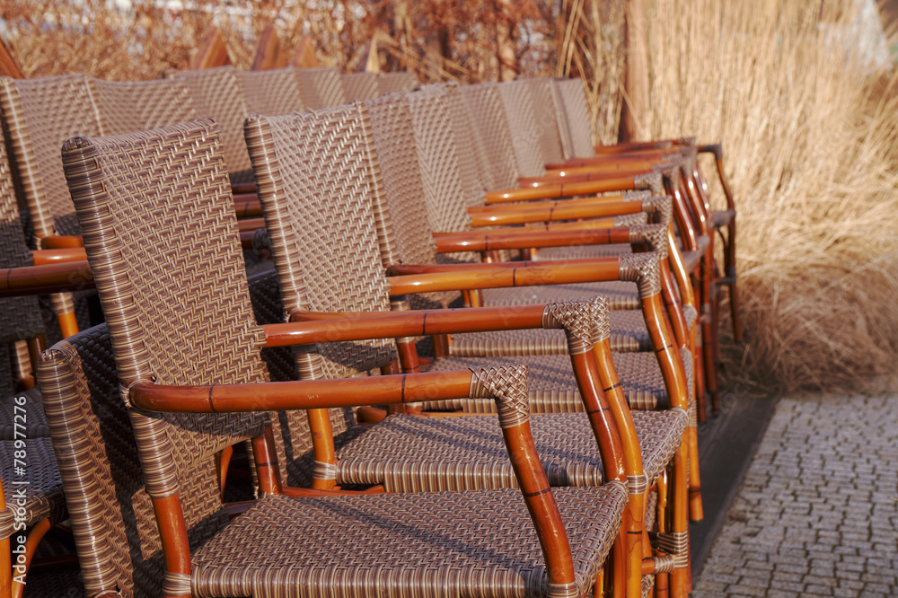 Wicker chairs on the terrace in the garden cafe.