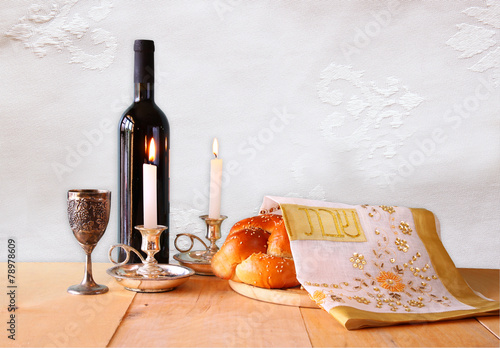 shabbat image. challah bread, shabbat wine and candelas on woode