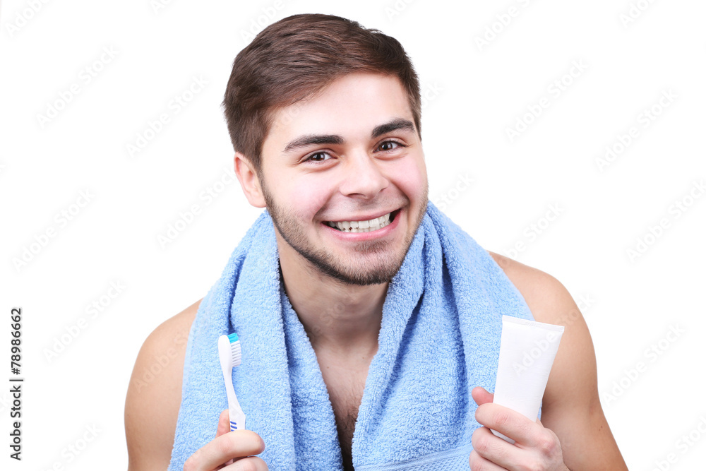 Portrait of young man with toothbrush and toothpaste in hands Portrait of young man with toothbrush and toothpaste in hands