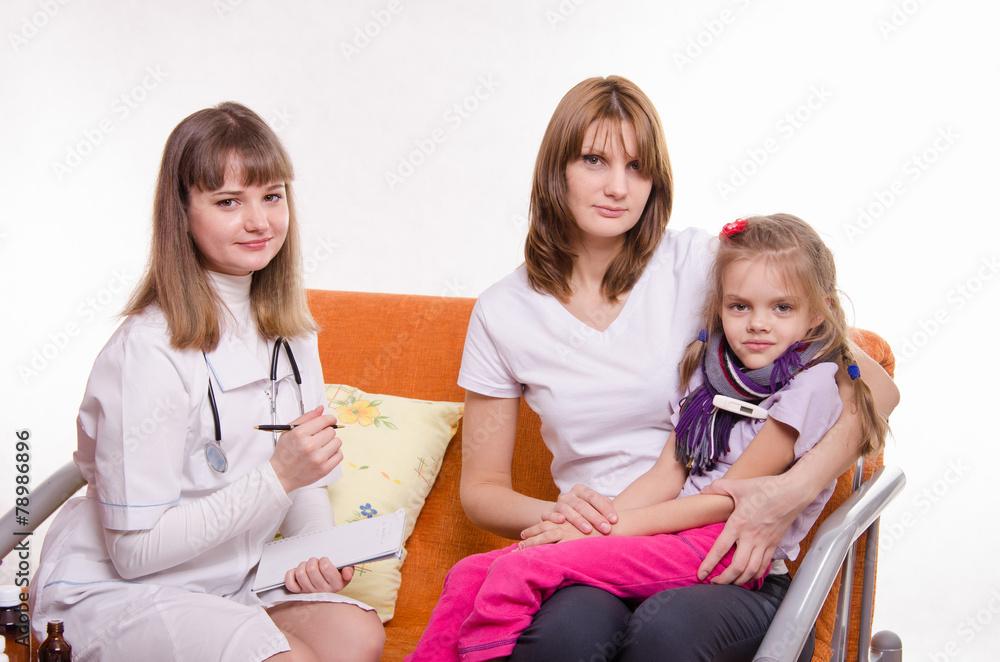 Sick girl measures the temperature and doctor writes a complaint Sick girl measures the temperature and doctor writes a complaint