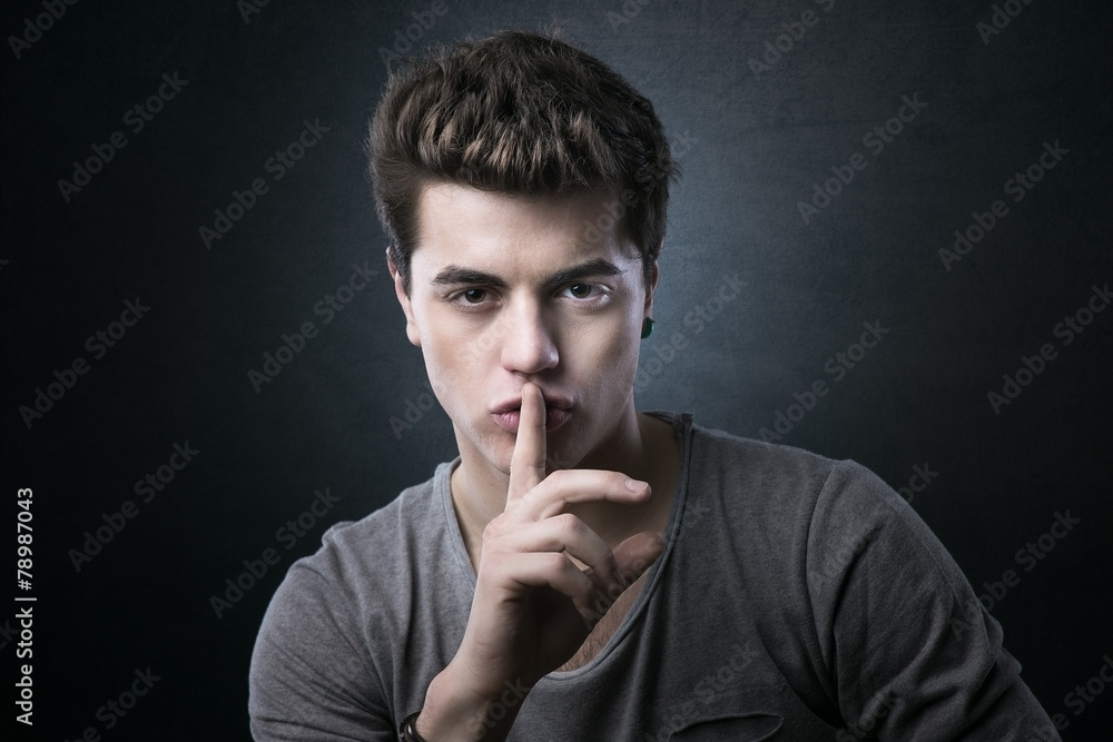 Young man making silence gesture Young man making silence gesture