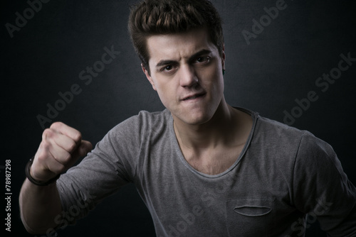 Young man showing fists © StockPhotoPro
