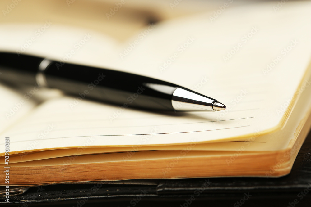 Writing pen on notebook background Writing pen on notebook background
