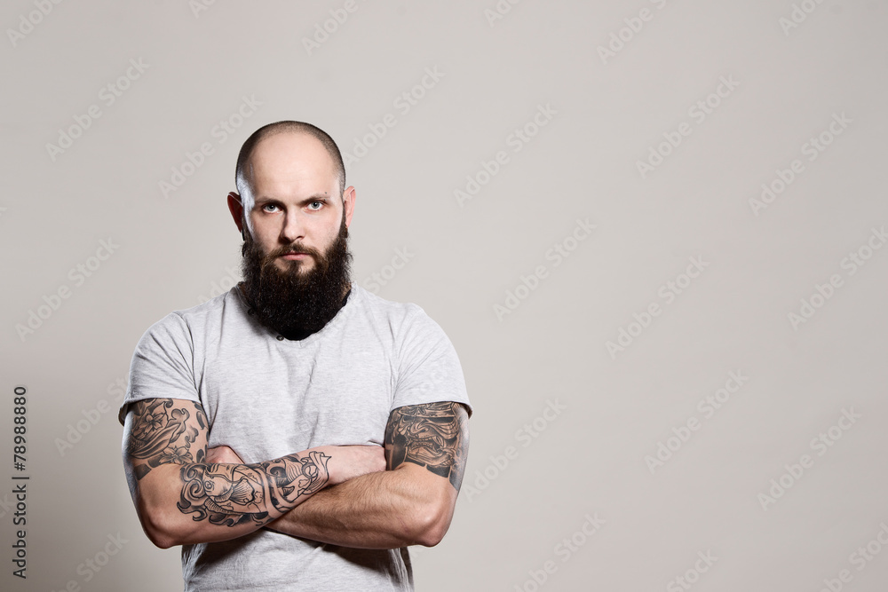 Bearded man with crossed arms