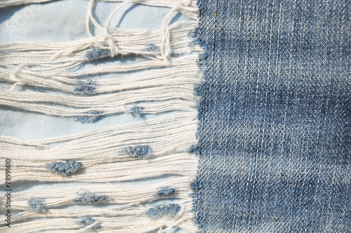 Closeup of tear in old jeans.