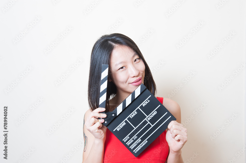 Young beautiful asian woman portrait posing with clapperboard Young beautiful asian woman portrait posing with clapperboard