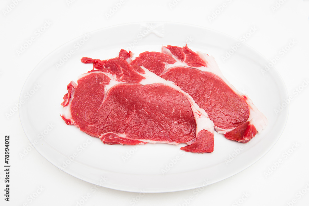 Two raw red sirloin beef on white plate