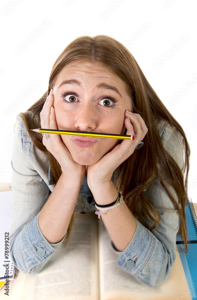 student woman holding pen between nose and lips student woman holding pen between nose and lips