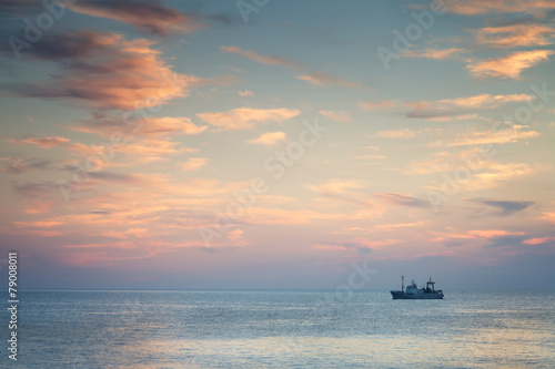 Ship in the sea at sunset © Aleksey Sagitov