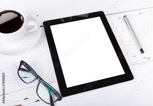 tablet and touch phone with isolated screen lie on a wooden with