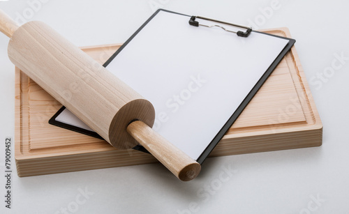 Rolling-pin, and blank clipboard on cutting board, closeup shot