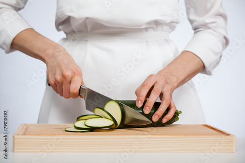 Female hands cutting zucchini