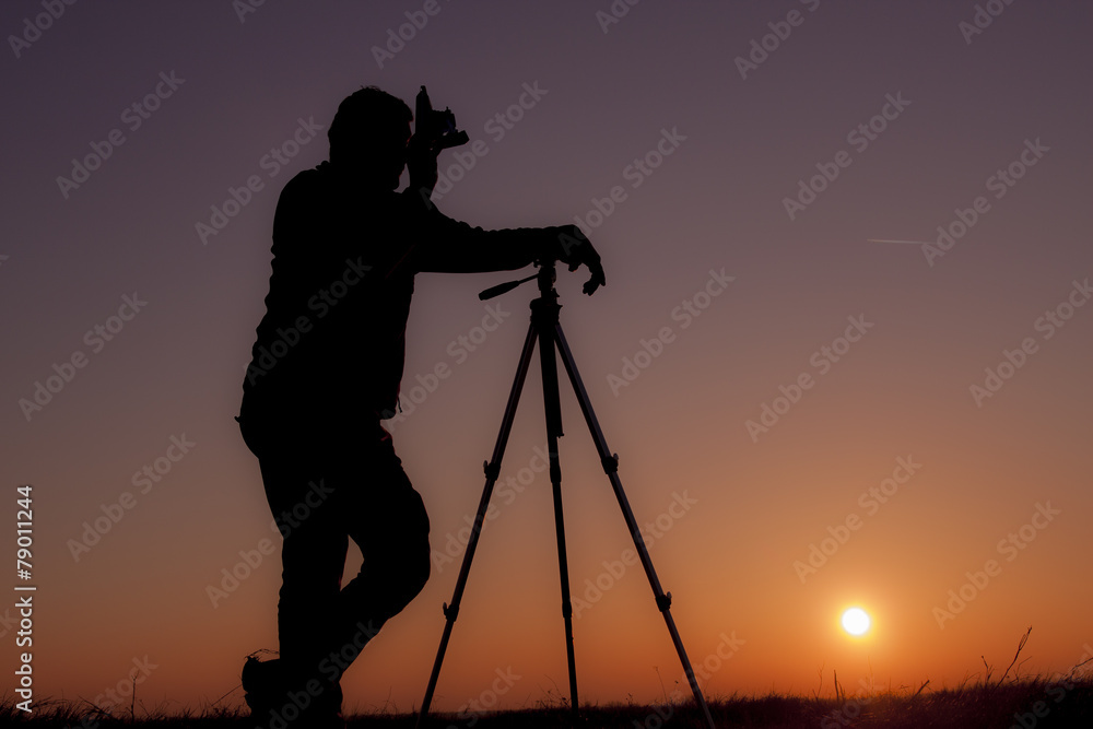 Man with old camera and tripod