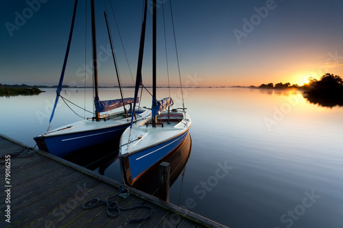 yacht on lake harbor at sunrise © Olha Rohulya