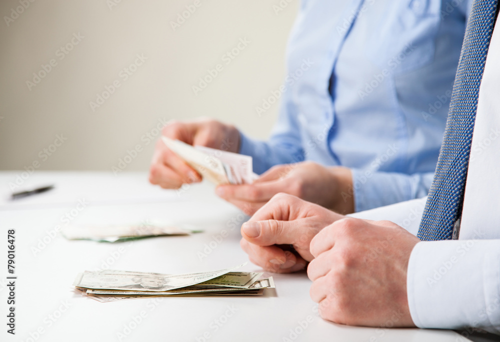 Business people counting banknotes Business people counting banknotes