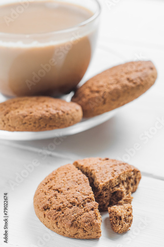 oatmeal cookie with coffee wooden white background