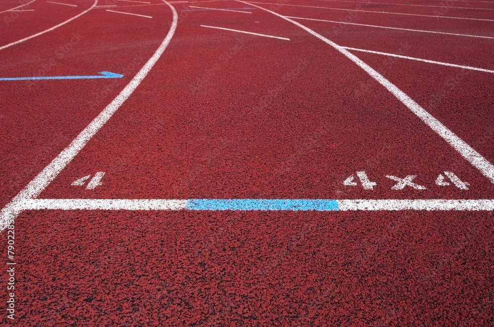 Red running field track with arrows and lines.