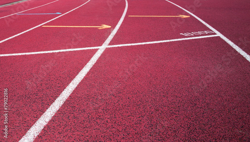 Red running field track with arrows and lines. © artesiawells