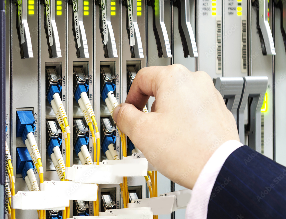 woman connecting network cables to switches woman connecting network cables to switches