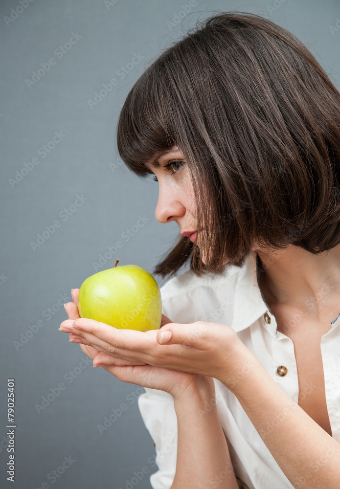 Beautiful girl holding a green apple Beautiful girl holding a green apple