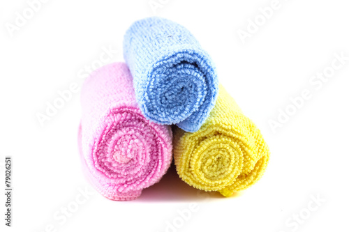 Red yellow and blue towel rolled up on a white background