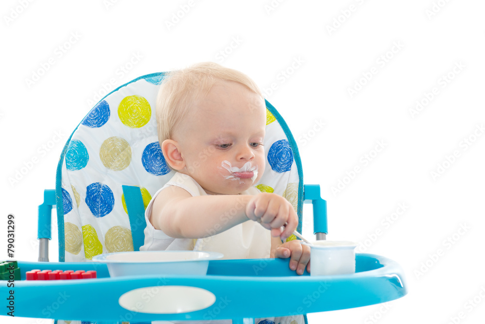 Sweet baby with spoon eats the yogurt. Sweet baby with spoon eats the yogurt.