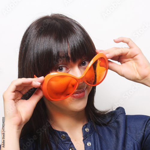 young happy woman with big orange sunglasses
