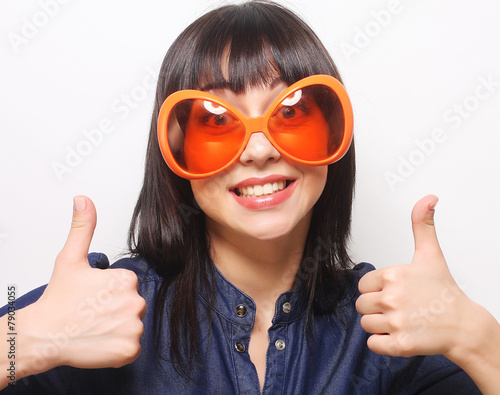 young happy woman with big orange sunglasses