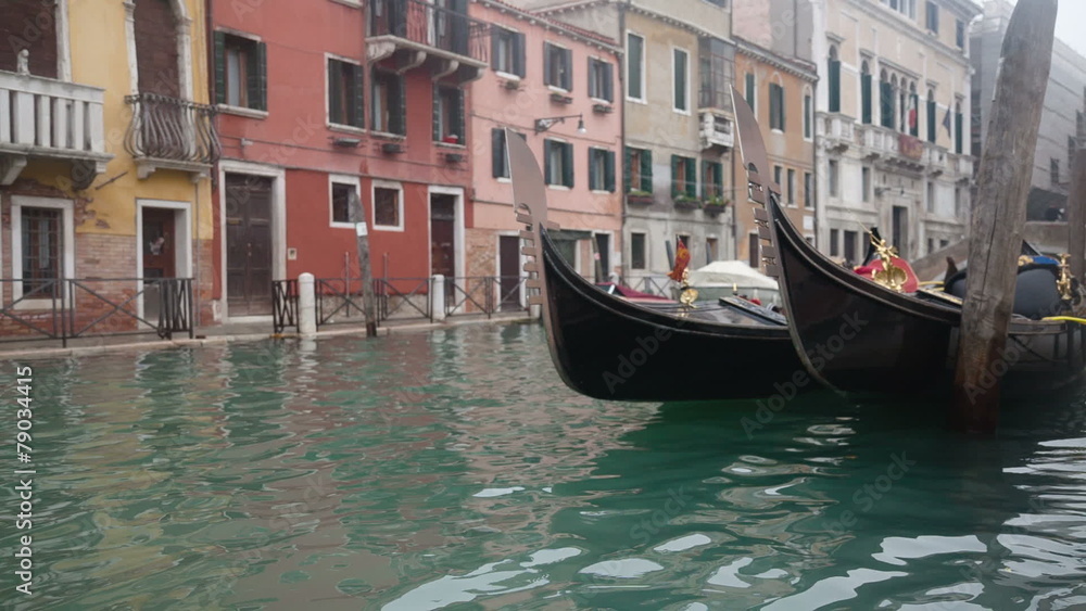 Gondolas in Venice at the pier at the channel Gondolas in Venice at the pier at the channel